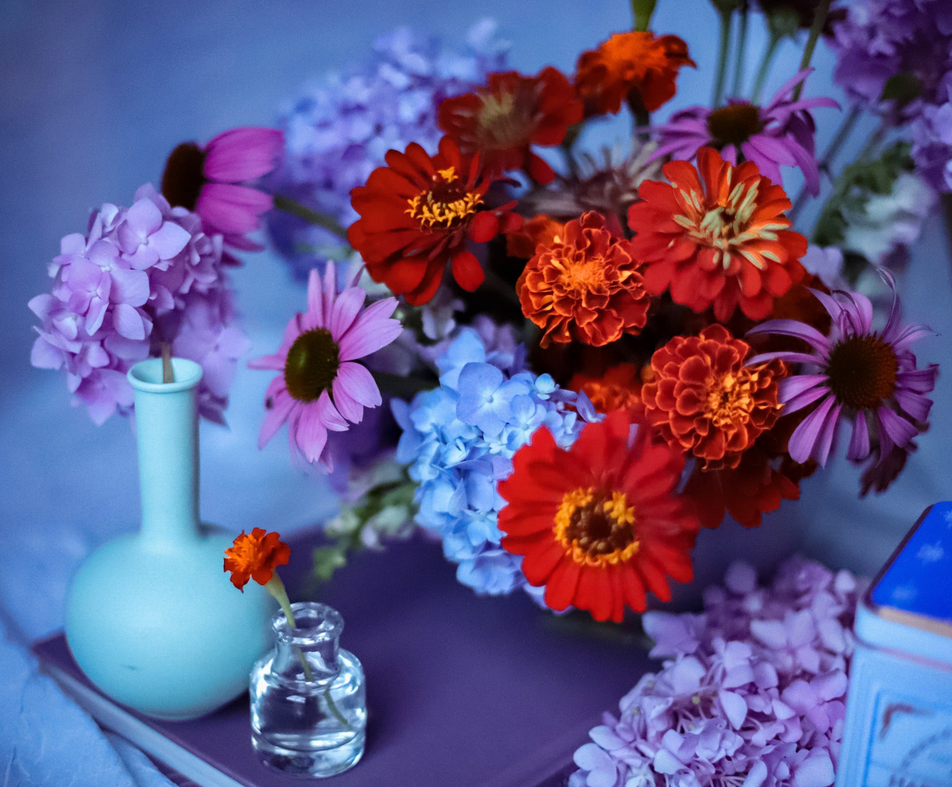 red, blue, and lavender brightly colored flower arrangement for a birthday