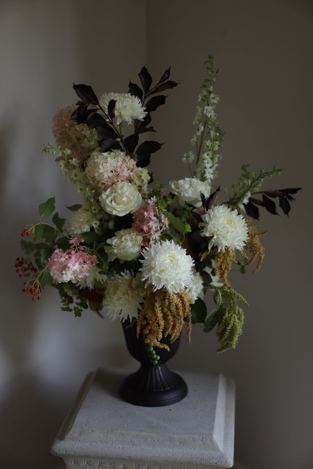 peaceful white flower arrangement with touches of seasonal late summer colors for memorial