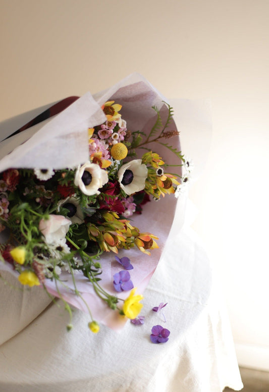 gift wrapped spring bouquet designed with anemones